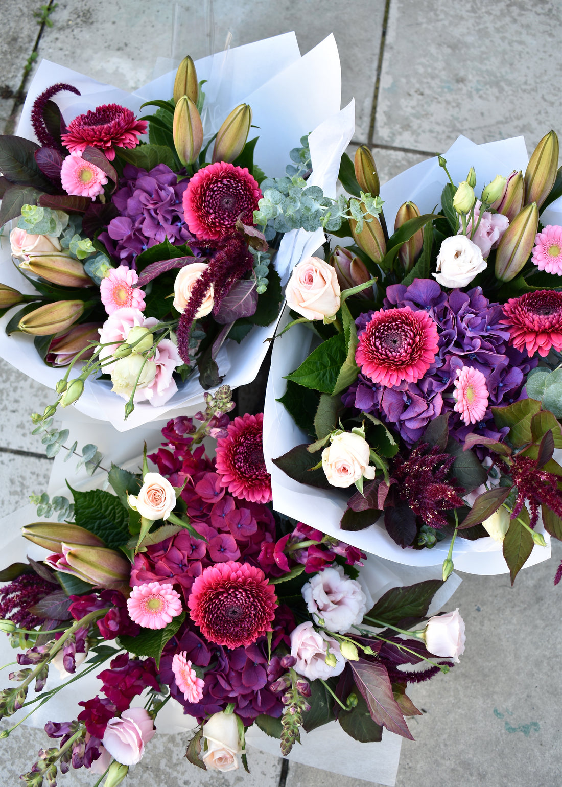 Seasonal Bouquet ‘Berry’ — a hand-tied mix of pink, purple, and red seasonal flowers, available for Christchurch flower delivery.