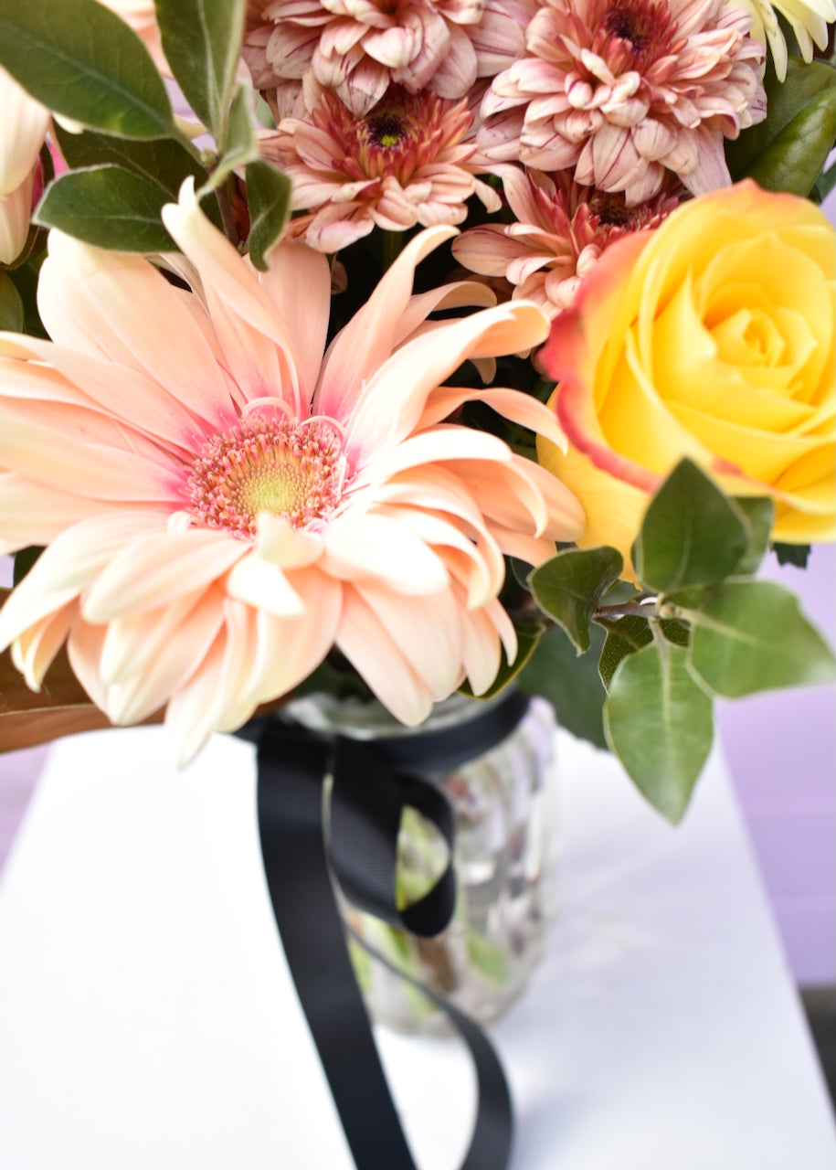 glass jar with colourful flower bouquet