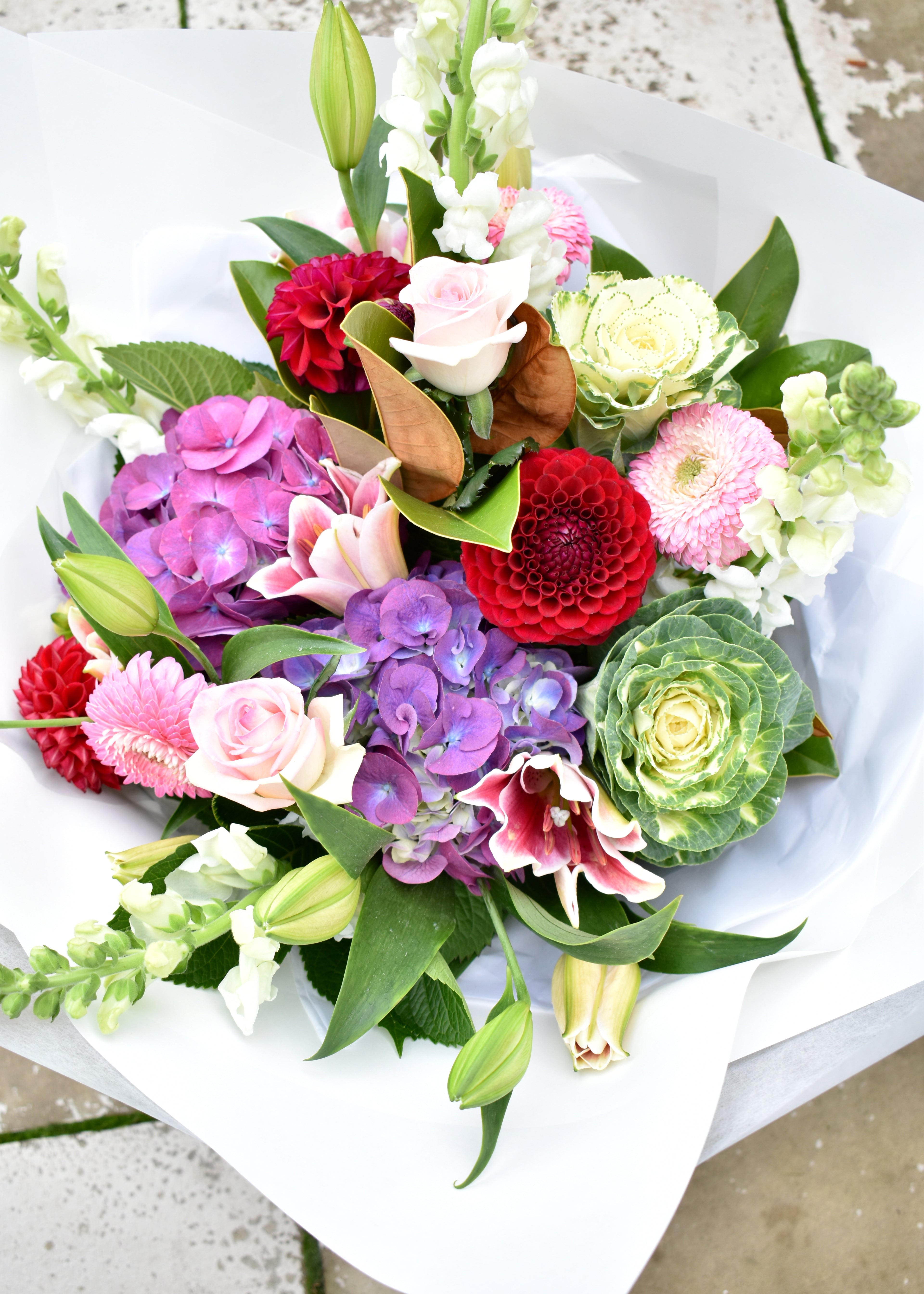 Seasonal flower bouquet. White, purple, red and pink. Roses, dahlia and lilies