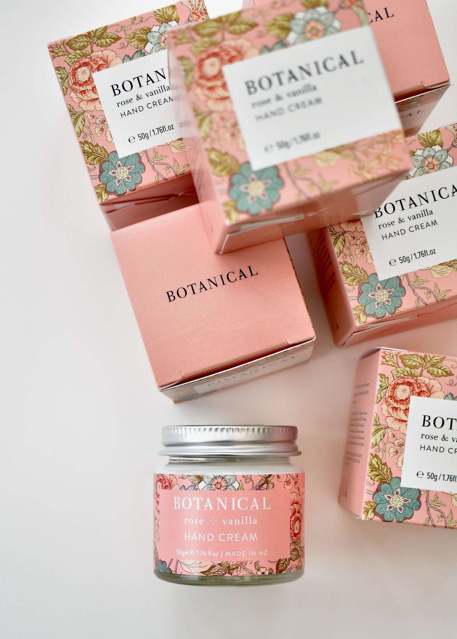 Floral pale pink packaging boxes with a jar of rose &amp; vanilla hand cream