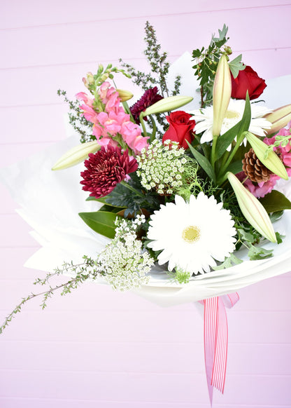 Christmas style fresh flower bouquet. Pink, red, white and green