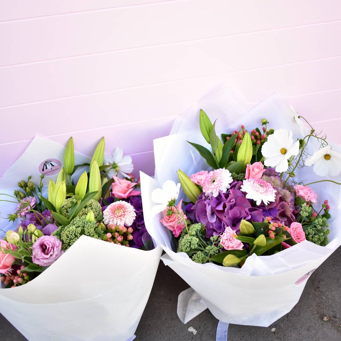 Summer flower bouquet, pink, white, purple and green wrapped in white paper