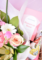 Pink and white gift hamper created by a florist. Containing a bouquet of fresh flowers, hand cream, bath bomb, rose tea and chocolate bar. Presented in white box with tissue.
