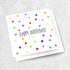A White greeting card with colourful spots and text reading "Happy Birthday".
