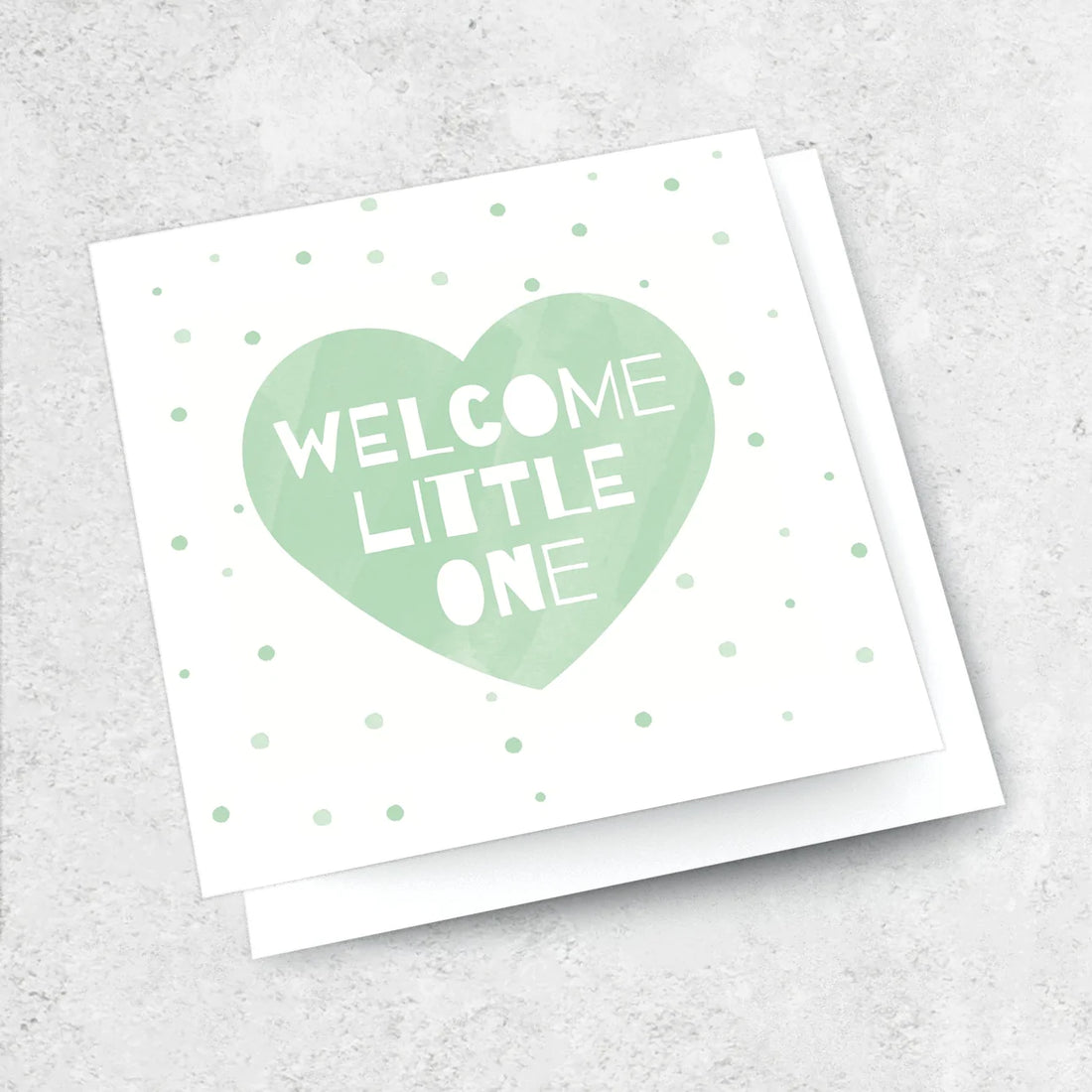 Greeting card for a new baby. green heart with the text &quot;welcome Little One written in white